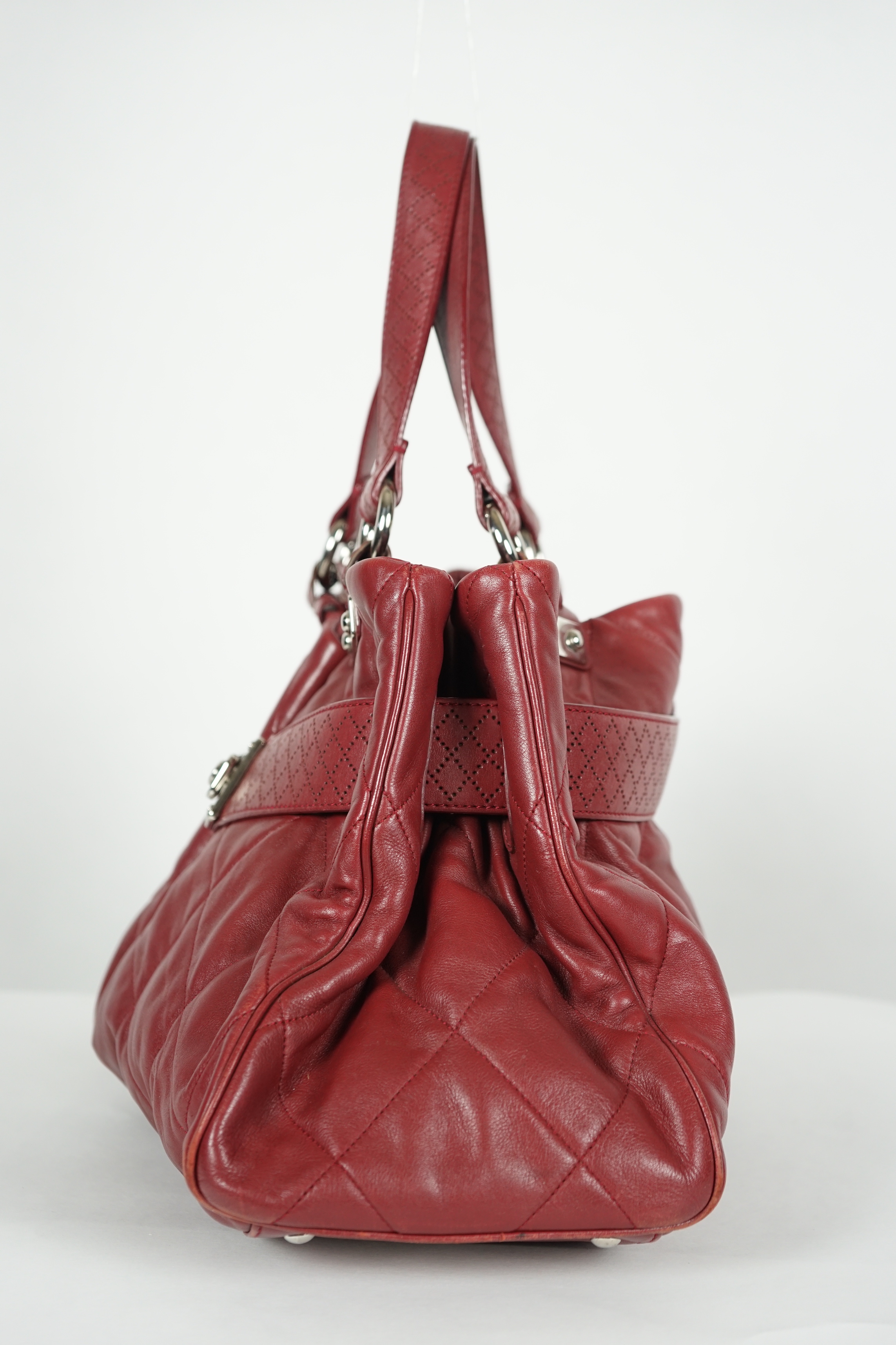 A Chanel burgundy leather buckled handle bag, with dust bag, width 45cm, height: 24.5cm, height overall 44cm, depth 16.5cm, Please note this lot attracts an additional import tax of 20% on the hammer price